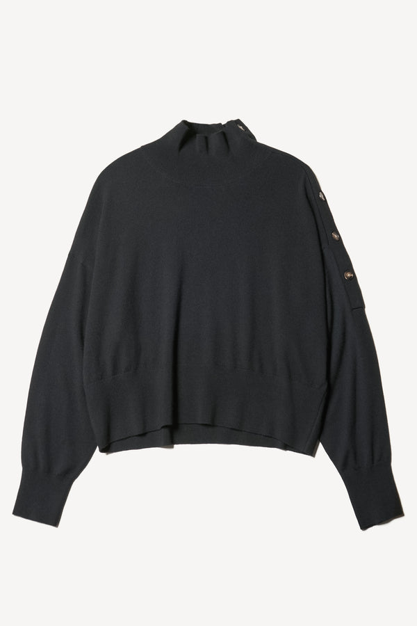 Flat front view of the Impart merino wool mock neck sweater with shoulder button detail in black.