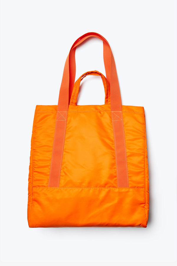 The back of the Influx Padded Bag, a practical tote in bright orange. Made from a strong, quick dry nylon.