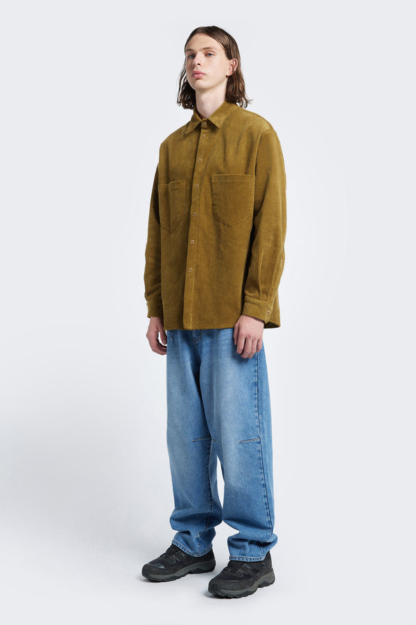 The Corner Cord Shirt in Golden Tan is a casual style shirt with details like scooped patch-pockets and rounded hemline.