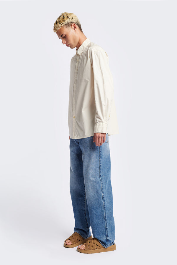 Front of the Iberia Long Sleeve Shirt in Ecru, featuring a built-in collar, semi-concealed placket, and a curved hem. Available in XS, S, M, L, XL