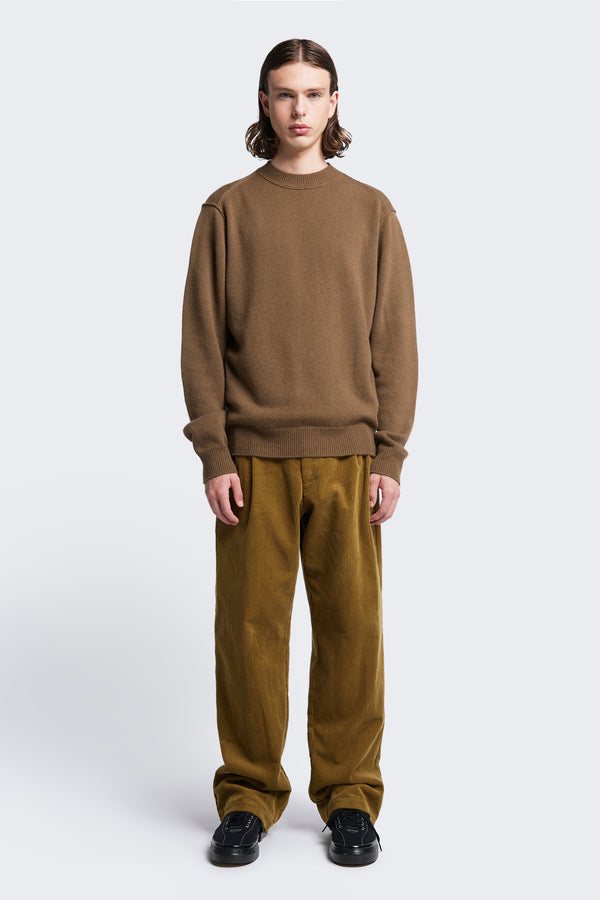 The Photic Sweater is a relaxed crew neck sweater with rib cuffs and hem. Knitted in a special finely textured wool/cashmere blend in Brown. Available in five sizes.