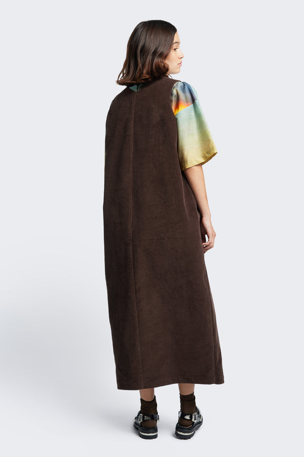 The back of the Arc Dress Brown, a full-length pinafore styled with the Outpost Top Cosmic Print. Made from thick wale corduroy.