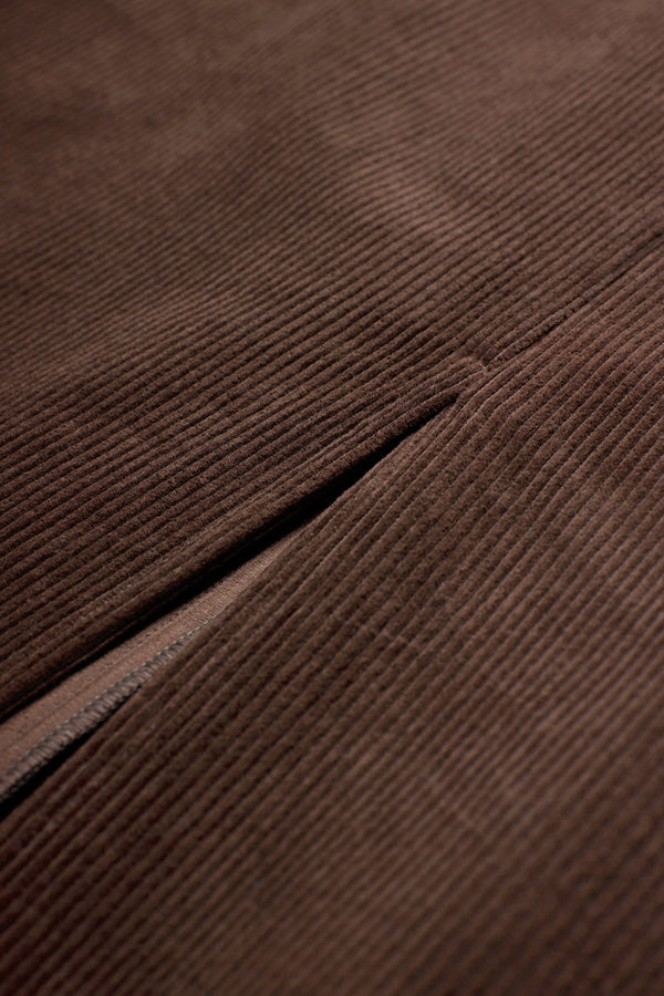Close up of the Arc Dress made from thick-wale corduroy in Dark Brown with a centre-front split.