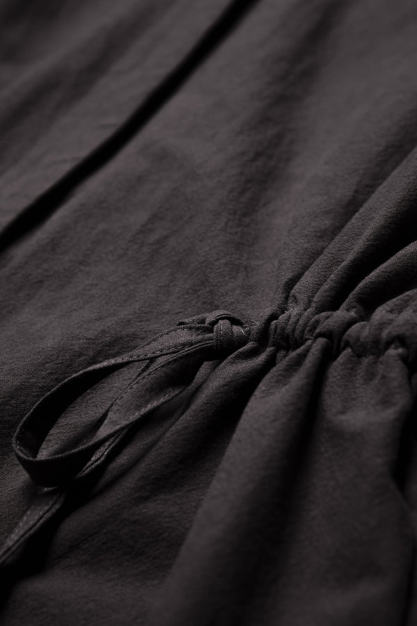 Close up of the waist ties on the Filter Dress Black. The waist ties allow you to adjust the shape to your liking. Made from 100% cotton.