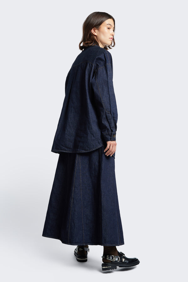 The back of the Idle Denim Skirt Indigo, a full godet style skirt with contrast stitch details. Crafted from Japanese denim.