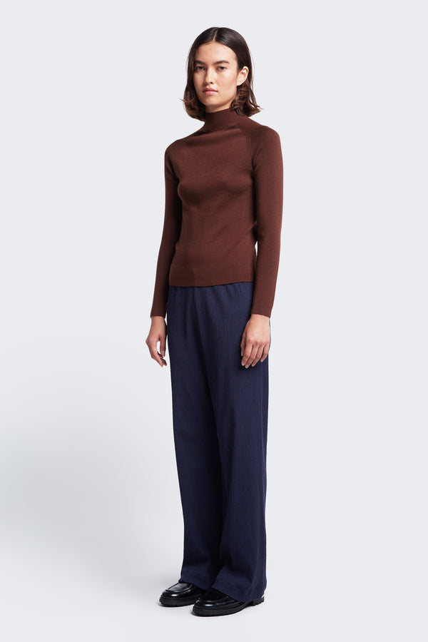 The Monument Mock Neck Sweater made from Merino wool in Brown. This slim fit sweater with a 1 x 1 rib stitch is an excellent layering option.