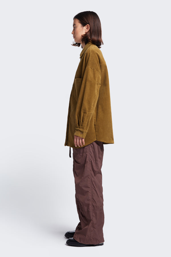 Side profile of the Proclaim Cord Shirt Golden Tan. A long sleeve shirt made from thick-wale corduroy.