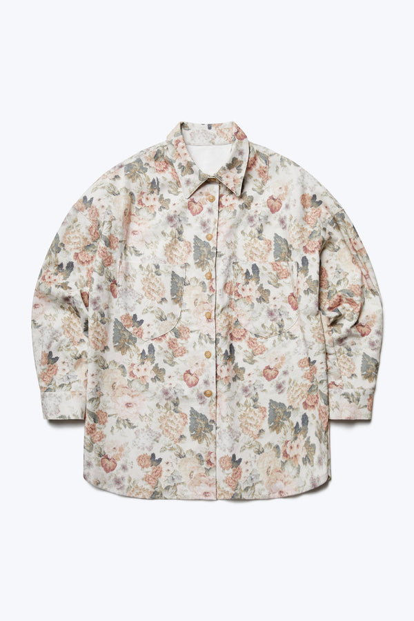 The front of the Resting Cord Shirt, a long sleeve, buttoned up shirt with two front patch pockets at the chest. Made from a fine wale corduroy in a floral print.