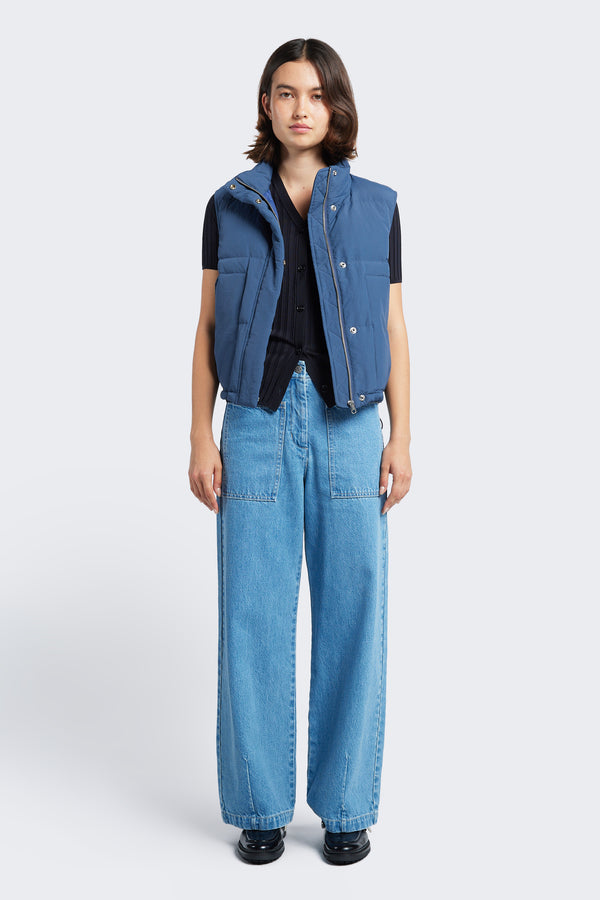 The Stay Quilted Vest Blue is a quilted down puffer vest with a high neckline for warmth, elasticated armholes for comfort and waist pull toggles to adjust the shape. Has a centre zip and stud press closure.