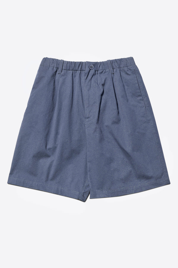 The Degree Pleat Short, a laidback and adaptable easy to weather summer short. Crafted in a blue washed cotton herringbone twill. Available in 5 sizes.