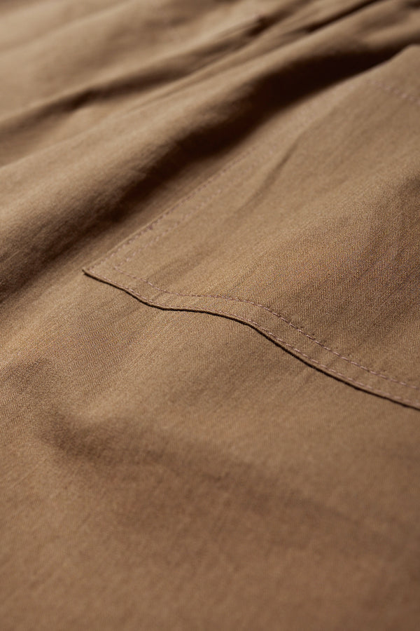 Close up fabric shot of The Degree Pleat Short, a laidback and adaptable easy to weather summer short. Crafted in a brown washed cotton herringbone twill. Available in 5 sizes.