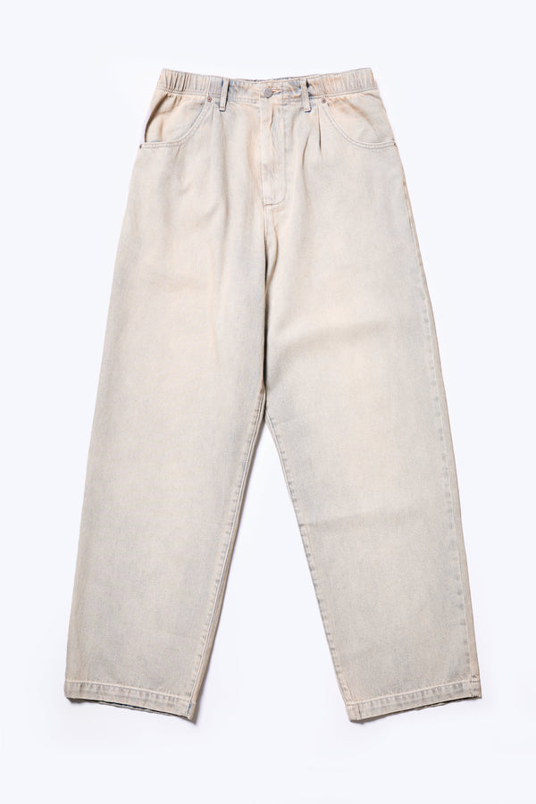 Flat Front of the Fragment Pleat Denim Pant in Blue pink Fade, a relaxed fit and loose leg design, featuring an elasticated waistband, traditional denim front pockets, and patch back pockets. Available in 5 sizes.