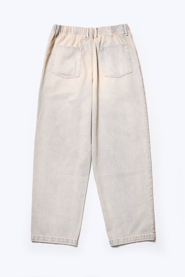 Flat back of the Fragment Pleat Denim Pant in Blue pink Fade, a relaxed fit and loose leg design, featuring an elasticated waistband, traditional denim front pockets, and patch back pockets. Available in 5 sizes.