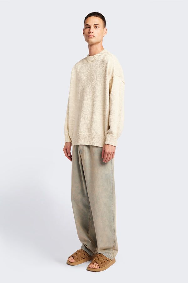 Front of the ecru Hill Slub Sweater in textured cotton slub knit with an oversized fit, raglan sleeves, and ribbed trim at the hem and cuffs.