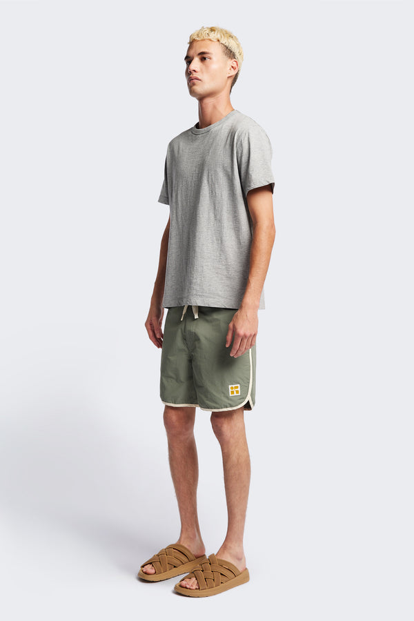 The Hybrid Board short in Sage, made from a functional technical cotton/nylon thats durable, stashable and quick-drying. Featuring back patch pocket with Velcro closure. Available in 5 sizes.