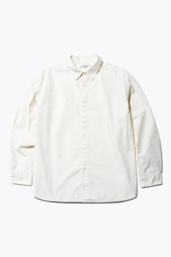 Flat Front of the Iberia Long Sleeve Shirt in Ecru, featuring a built-in collar, semi-concealed placket, and a curved hem. Available in XS, S, M, L, XL