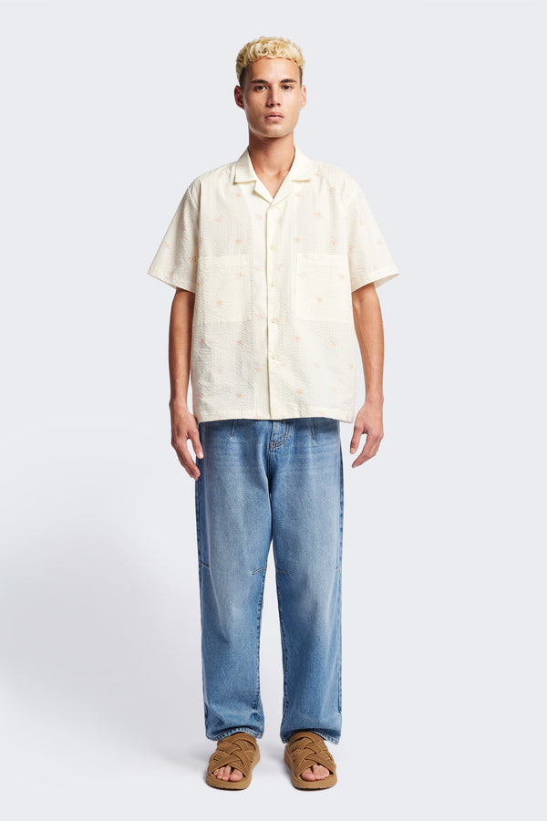 Front of the Mirari in Ecru floral, a relaxed short-sleeve open-collar camp shirt made from soft textured cotton seersucker, offering a laid-back fit. Available in 5 sizes.