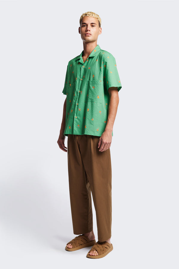 Front of the Mirari in Green floral, a relaxed short-sleeve open-collar camp shirt made from soft textured cotton seersucker, offering a laid-back fit. Available in 5 sizes.