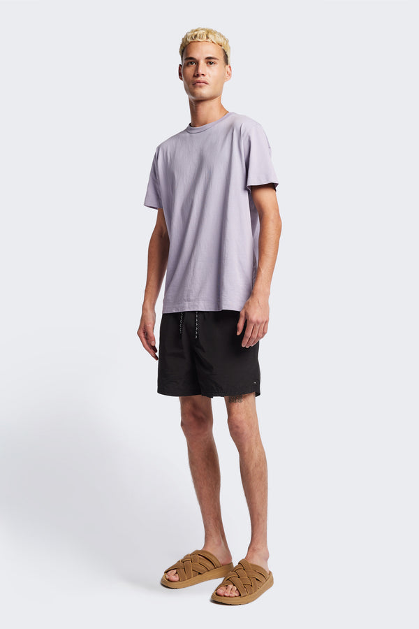 The New Wave Short in Black. Swim shorts with elastic drawstring waist, internal mesh support, and front slant pockets. Available in 5 sizes.