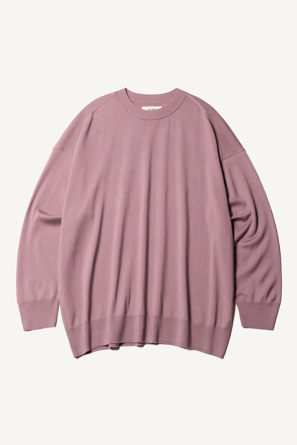 Flat Front the Pitch loose fit merino wool crew neck sweater with exposed seams in mauve.