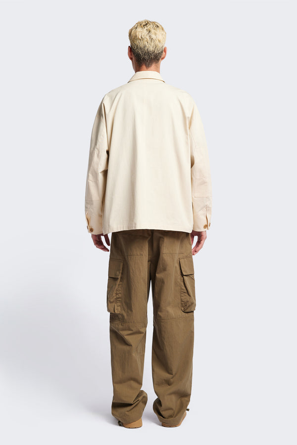 Back of The Pressure Jacket in Chalk White, a relaxed boxy long sleeve jacket in washed cotton herringbone with 3D patch pockets and hidden zip openings. Available in 5 sizes.