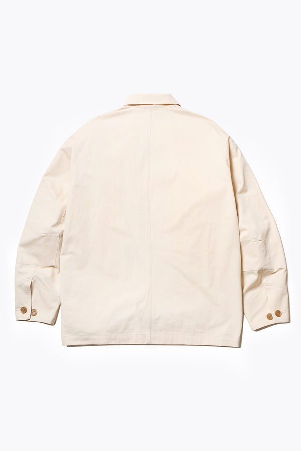 Back The Pressure Jacket in Chalk White, a relaxed boxy long sleeve jacket in washed cotton herringbone with 3D patch pockets and hidden zip openings. Available in 5 sizes.