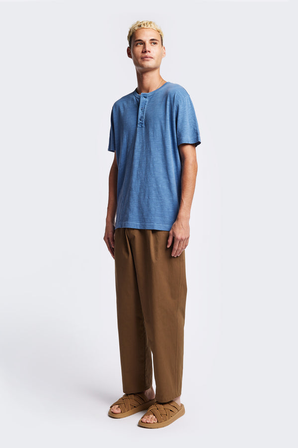 The Stratus Henley T-shirt in Blue. Garment-dyed in soft cotton jersey with three-button placket and coverstitched hems. Available in 5 sizes.