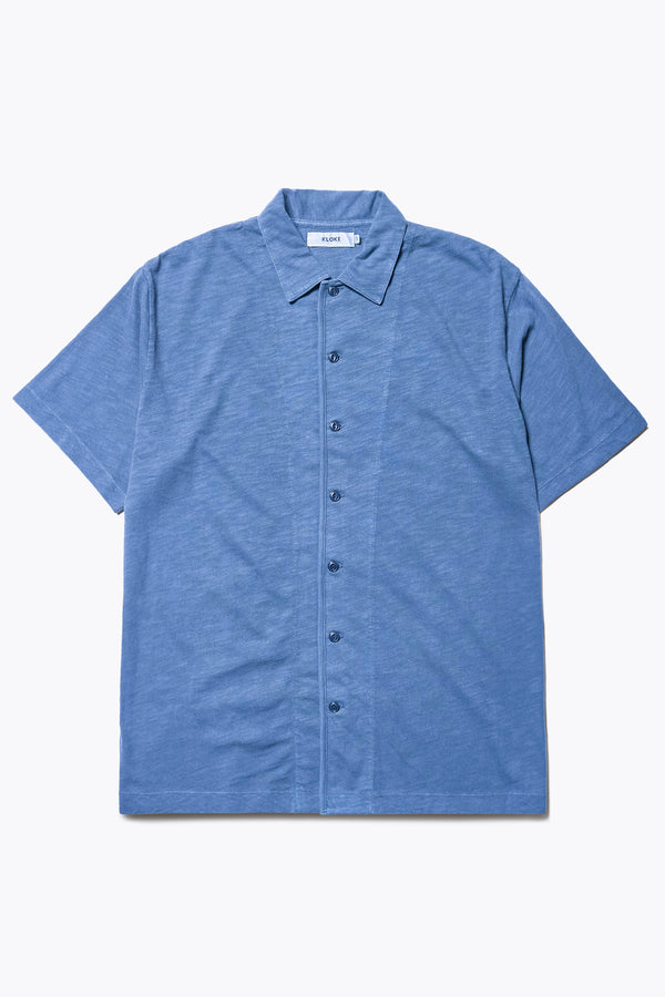 The Tectonic Shirt in blue, a classic boxy fit T-Shirt made from 100% cotton garment dyed jersey with a reinforced back yoke. Available in 5 sizes.