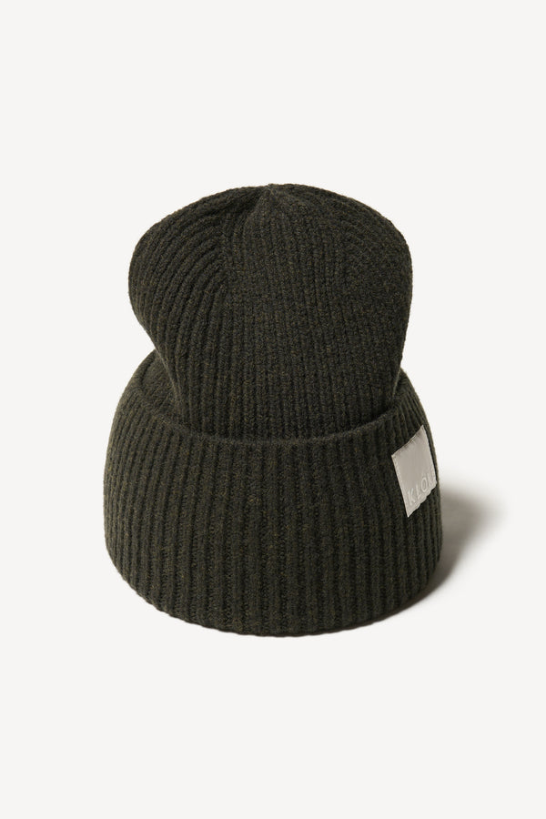Close up fabric shot of ribbed knit beanie showing texture in Darkest Green