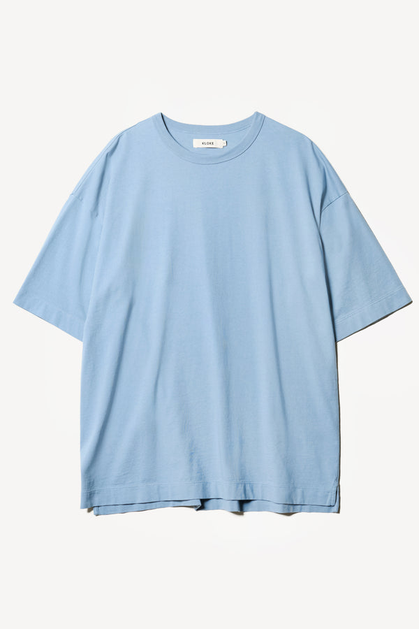 Flat Front of the Monolith Unisex Tee in Blue. Oversized relaxed fit. Available in 6 sizes. Made from 100% Organic Cotton.