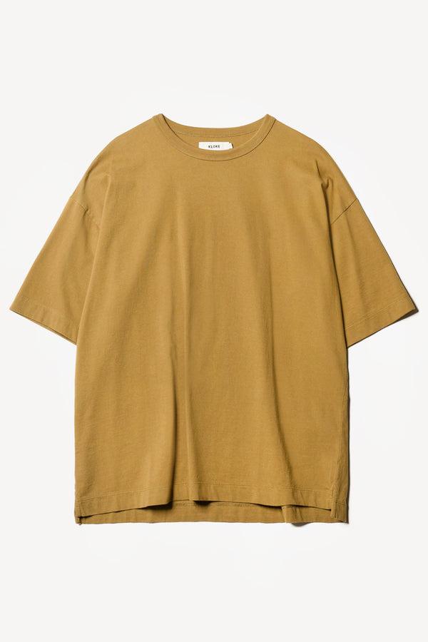 Flat Front of the Monolith Unisex Tee in Olive Oil. Oversized relaxed fit. Available in 6 sizes. Made from 100% Organic Cotton.