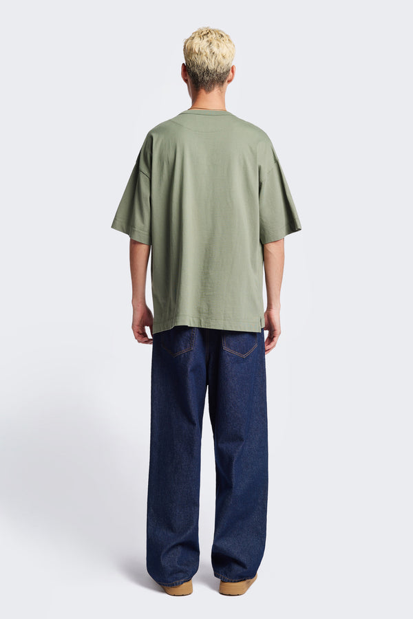 Back of the Men Monolith Unisex Tee Sage Green. Oversized relaxed fit. Available in 6 sizes.