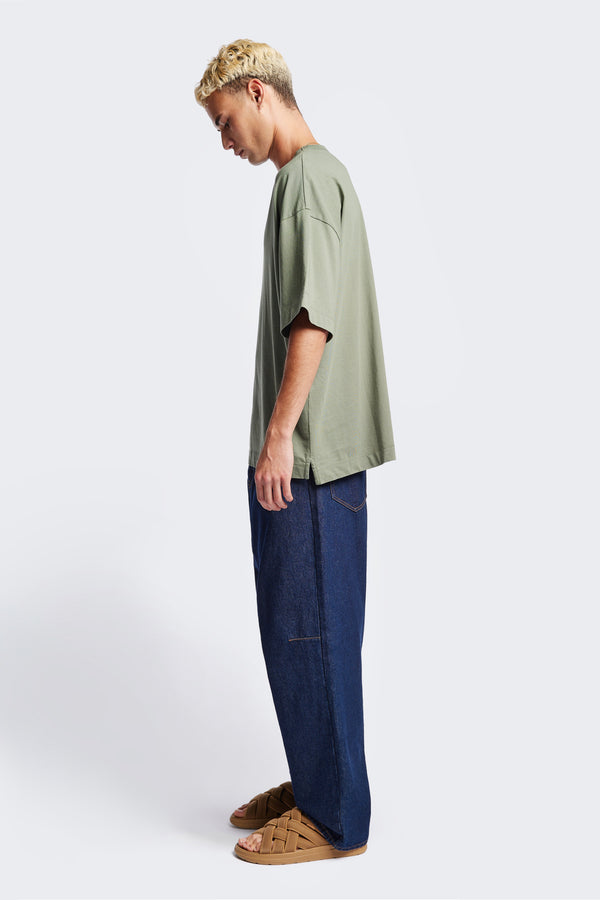 Side of the Men Monolith Unisex Tee Sage Green. Oversized relaxed fit. Available in 6 sizes.