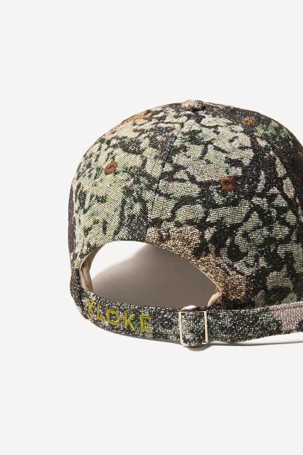 Flat back view of the Orbital Jacquard Cap in Green Print - highlighting embroidered branding on back strap
