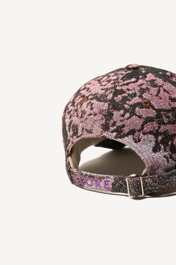 Flat back view of the Orbital Jacquard Cap in Purple Print - highlighting embroidered branding on back strap