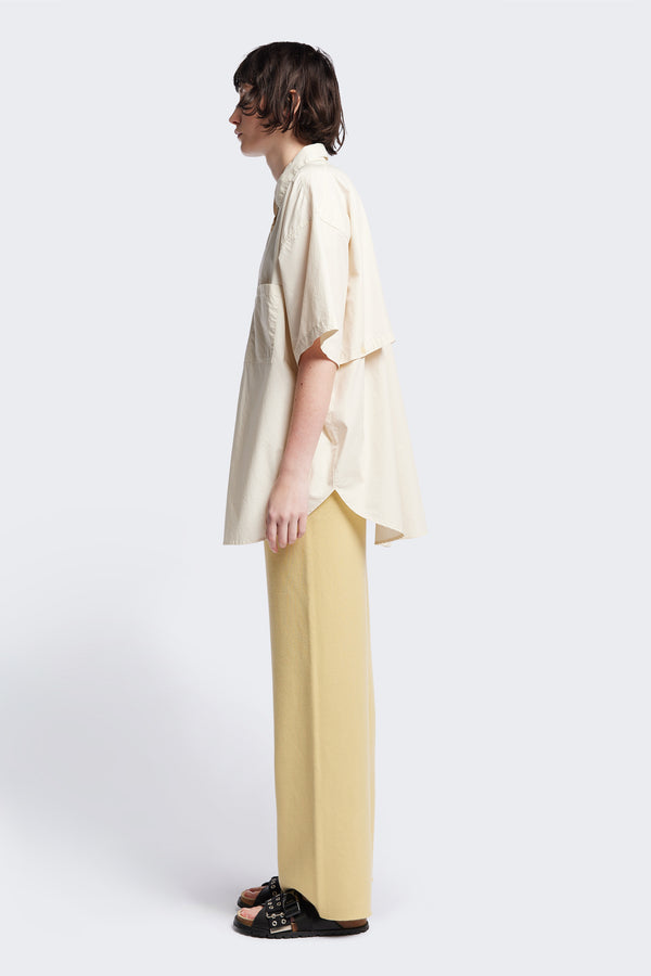 (women) Relaxed loose-fitting boxy short-sleeve shirt with back button placket, scoop hemline, and chest patch pockets, crafted in lightweight cotton poplin. Available in 5 sizes.