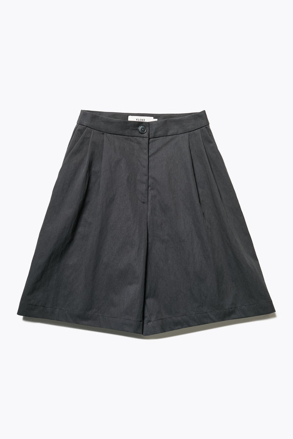 Tailored Depth Short in Black, crafted from soft cotton with pleat front detail, slant pockets, and a relaxed wide leg. Finished with back dart detailing and patch pockets. Available in 6 sizes.