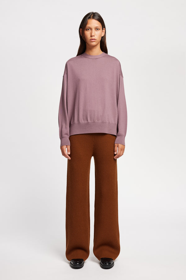 Front view on Model of the Descend Loose Fit Merino Knit in Mauve relaxed-fit merino wool sweater with a crew neck.