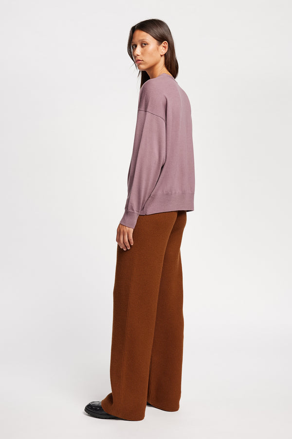 Back angle view on Model of the Descend Loose Fit Merino Knit in Mauve relaxed-fit merino wool sweater with a crew neck.