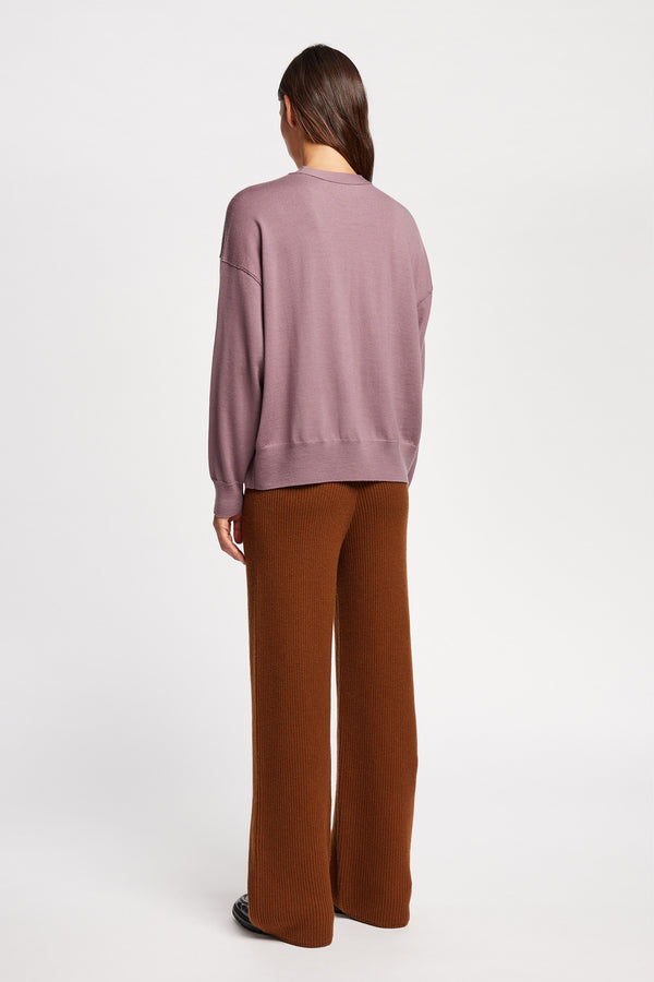 Back view on Model of the Descend Loose Fit Merino Knit in Mauve relaxed-fit merino wool sweater with a crew neck.