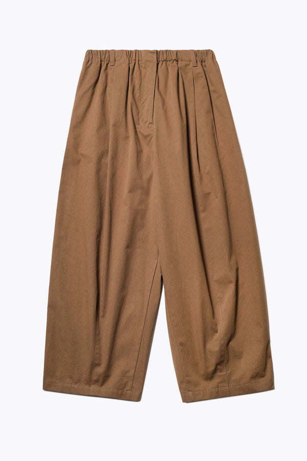 The Factor Pleat Pant in Brown. A relaxed-fit pants with an encased elastic waistband, darted hem detail, side entry pockets, and back patch pockets. Comfortable and perfect for summer. Available in 6 sizes.