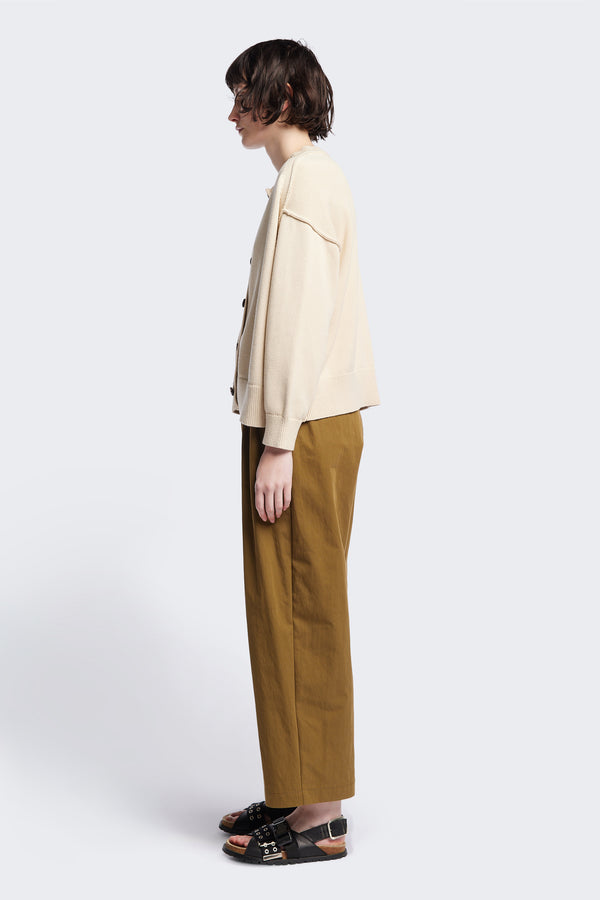 Side view of the Flow Cardigan in Ecru Beige , relaxed boxy cardigan in soft cotton yarn with a crew neckline, button closure, and exaggerated dropped shoulders. Available in 5 sizes.