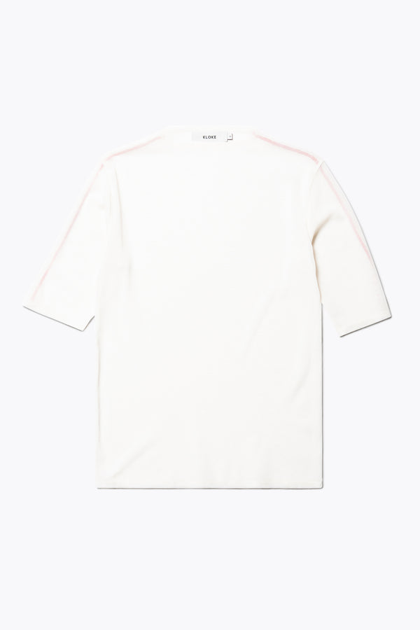 Flat Front of the Flow Mesh Short Sleeve Top in Ecru and Red. Featuring a high neckline, contrast flatlock seams, and sheer, lightweight fabric, perfect for layering.