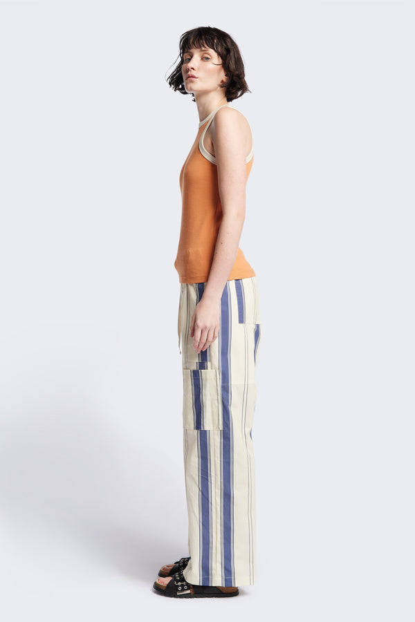 Side of Kloke Flux Racer Back Tank in Pastel Orange and Ecru Japanese ribbed cotton, featuring a slim fit and slight racer neckline, perfect for layering. Available in 5 sizes.