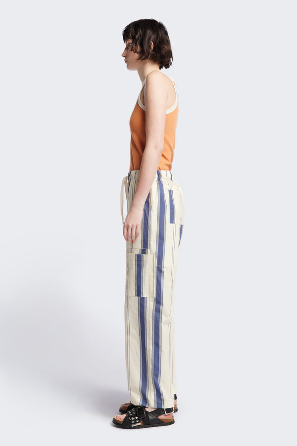 Side of Kloke Flux Racer Back Tank in Pastel Orange and Ecru Japanese ribbed cotton, featuring a slim fit and slight racer neckline, perfect for layering. Available in 5 sizes.