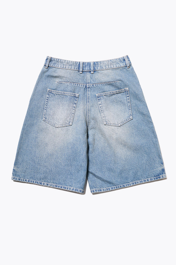 Back of The Fuego Longline denim shorts in a blue fade with a subtle pink tint, featuring darted waist details and a relaxed wide-leg design. Available in 6 sizes.