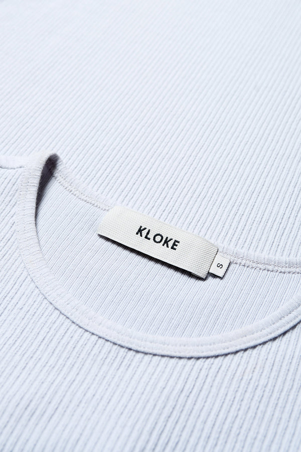 Close-Up Detail: Soft Japanese rib knit fabric with subtle stretch, highlighting the single bind trim at the neckline