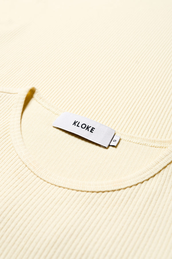 Close-Up Detail: Soft Japanese rib knit fabric with subtle stretch, highlighting the single bind trim at the neckline