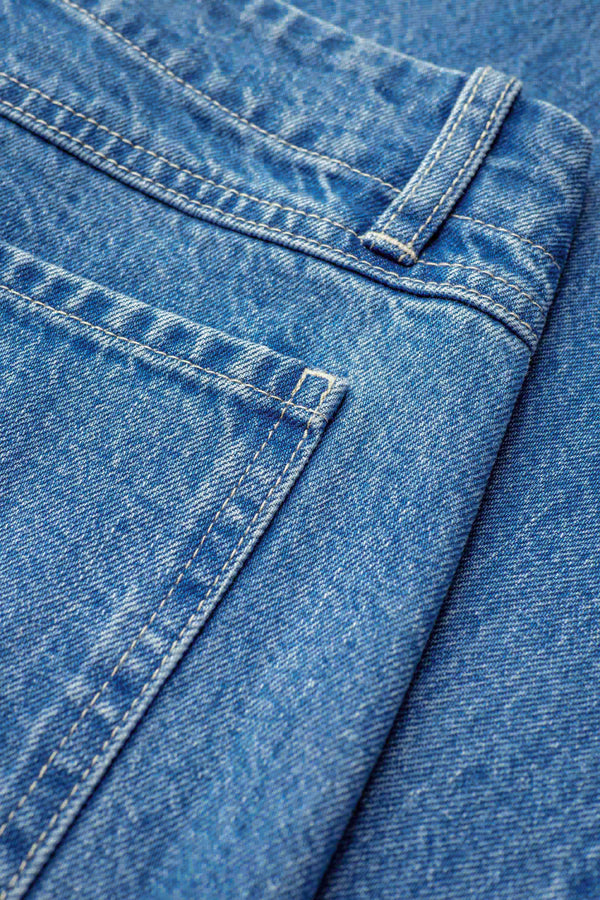 Close up of The Interval Jean in Mid Wash. A well-loved Kloke classic. A straight, wide leg with higher rise waist, back yoke detail, and feature patch pockets. Crafted from premium 12oz Japanese denim. Available in 10 sizes.