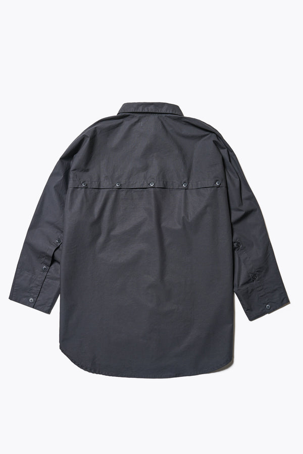Flat Back of Kestrel Shirt Black – relaxed long sleeve shirt with back button placket and scoop hemline, worn by model. Available in XXS, XS, S, M, L